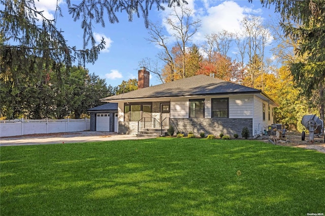 view of front of house with a garage and a front lawn