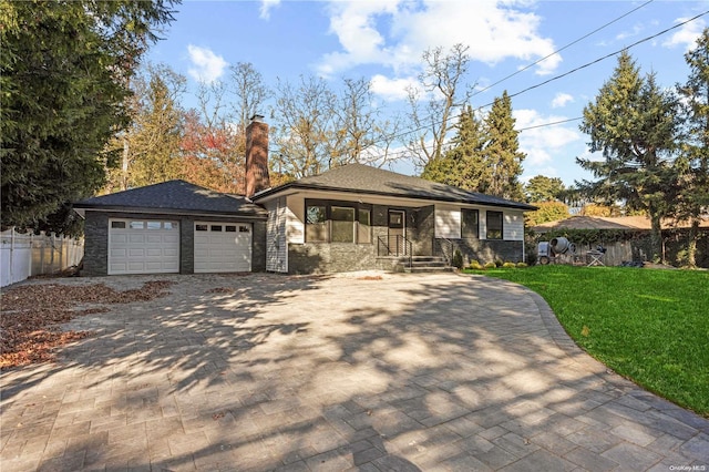 view of front facade with a garage, covered porch, and a front yard