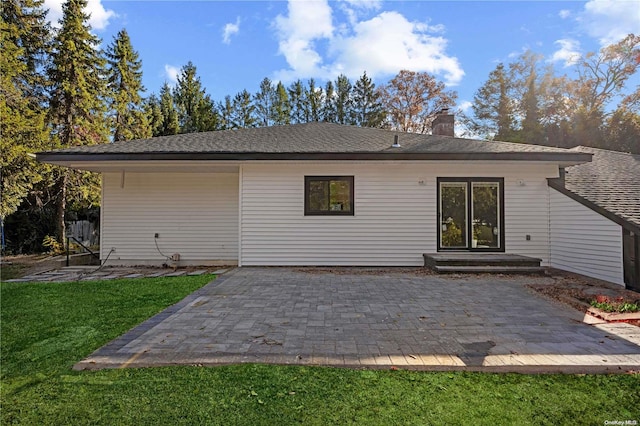 back of house featuring a yard and a patio