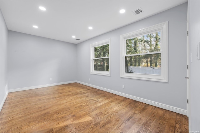 unfurnished room with light wood-type flooring