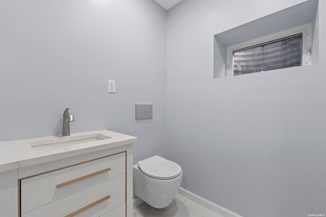 bathroom featuring tile patterned flooring, vanity, and toilet