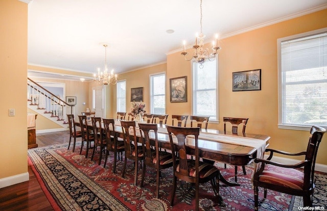 dining room with dark hardwood / wood-style flooring, ornamental molding, and a chandelier