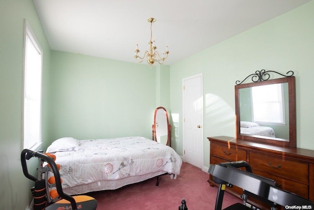 bedroom with multiple windows, carpet floors, and an inviting chandelier