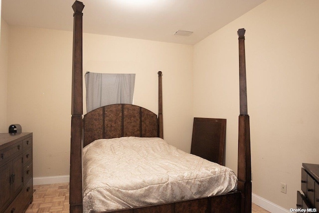 bedroom with light parquet floors