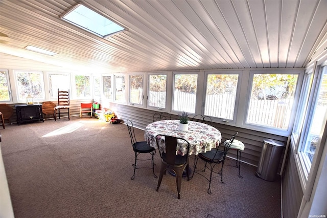 sunroom / solarium with vaulted ceiling with skylight and wood ceiling