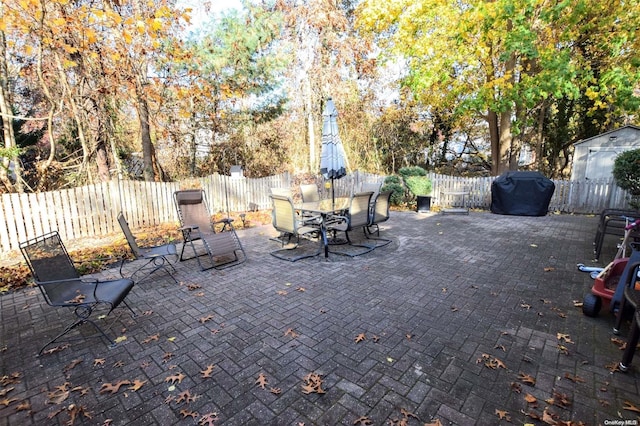 view of patio featuring a storage shed