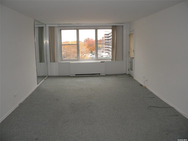212-30 23rd Ave Unit 6A, Bayside, NY 11360 - unfurnished room featuring radiator and light carpet
