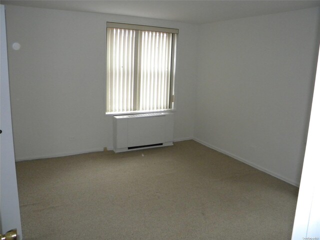 212-30 23rd Ave Unit 6A, Bayside, NY 11360 - unfurnished room with radiator and light colored carpet