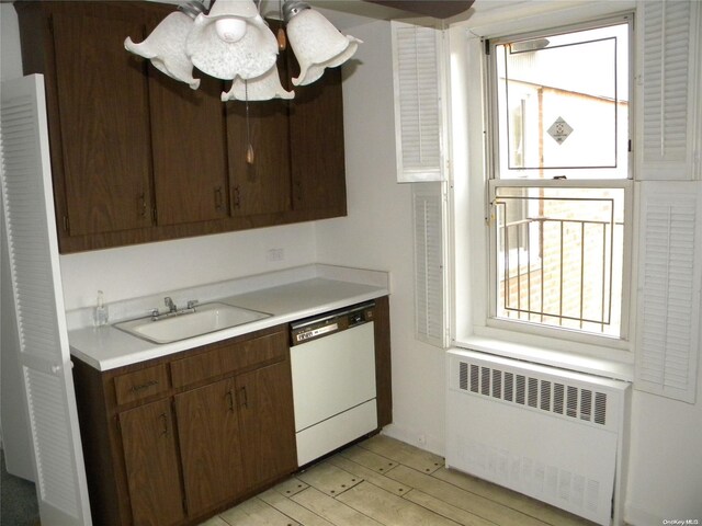 212-30 23rd Ave Unit 6A, Bayside, NY 11360 - kitchen with radiator heating unit, dishwasher, light countertops, light wood-type flooring, and dark brown cabinetry