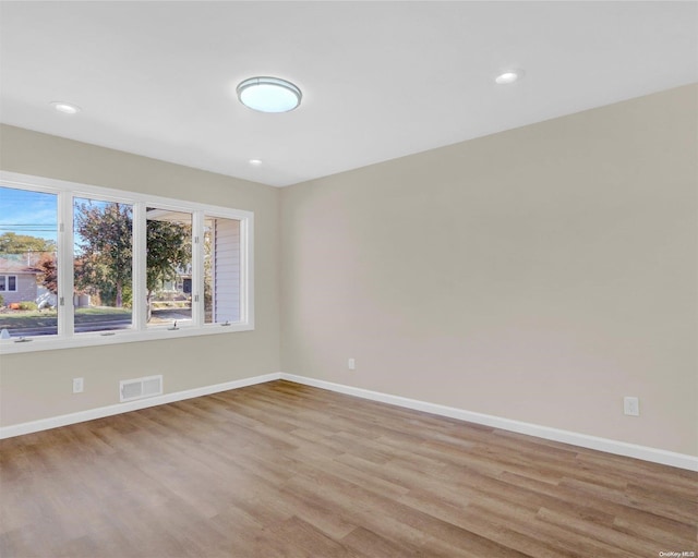 unfurnished room featuring light hardwood / wood-style floors