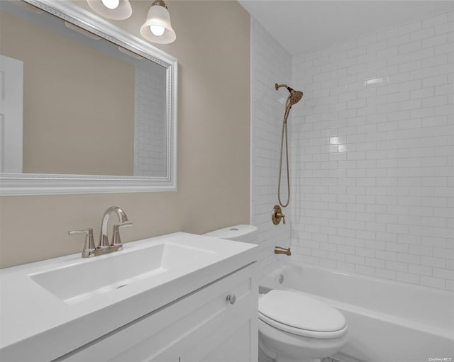 full bathroom with vanity, toilet, and tiled shower / bath combo