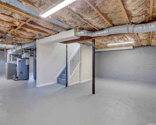 basement featuring heating unit and water heater