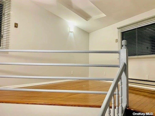 25-54 37th St, Astoria, NY 11103 - staircase with wood finished floors, baseboard heating, and vaulted ceiling