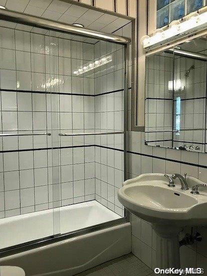 25-54 37th St, Astoria, NY 11103 - bathroom with enclosed tub / shower combo and tile walls