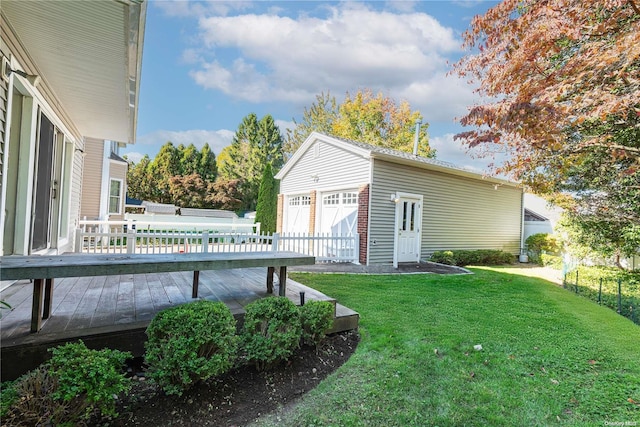 view of yard featuring a wooden deck, an outdoor structure, and a garage