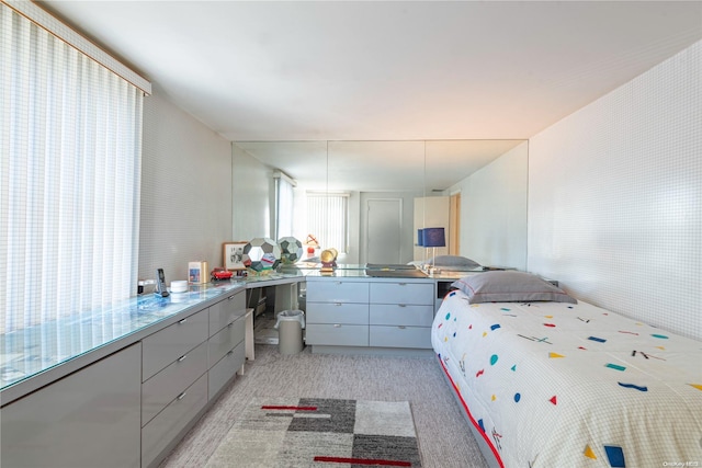 bedroom featuring light colored carpet