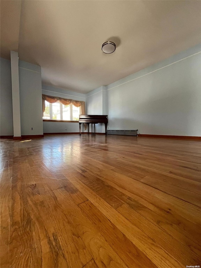 spare room featuring wood-type flooring