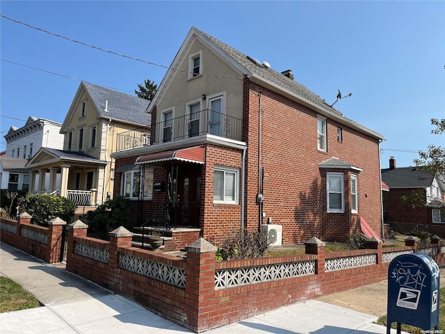 view of front facade with ac unit and a balcony