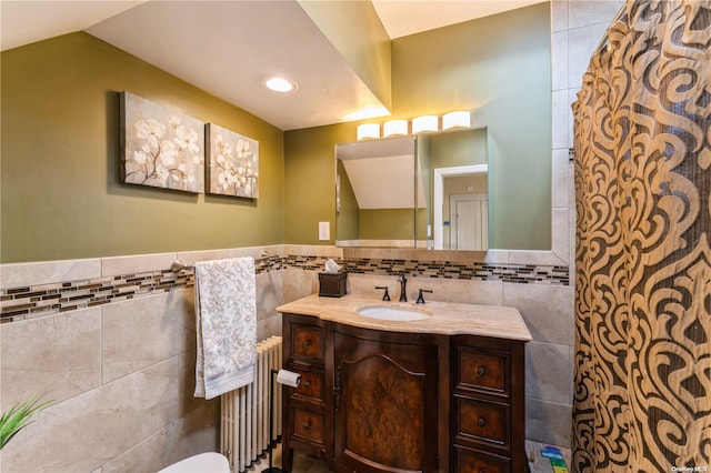 bathroom with vanity, tile walls, and radiator