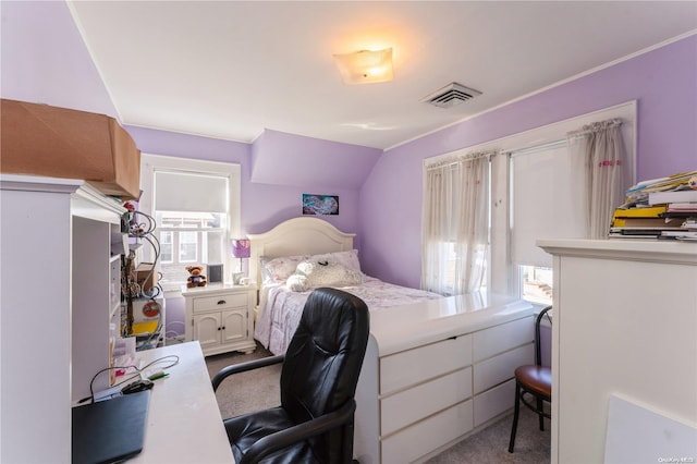 carpeted bedroom with vaulted ceiling