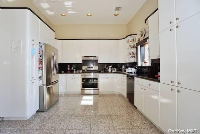 kitchen featuring decorative backsplash, white cabinets, and stainless steel appliances