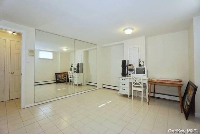 interior space with light tile patterned floors and a baseboard radiator