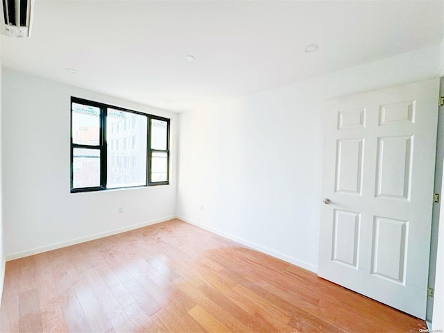 empty room with light hardwood / wood-style floors