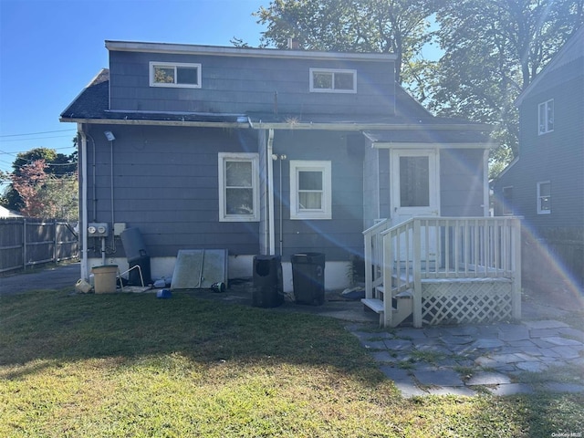 rear view of house with a yard