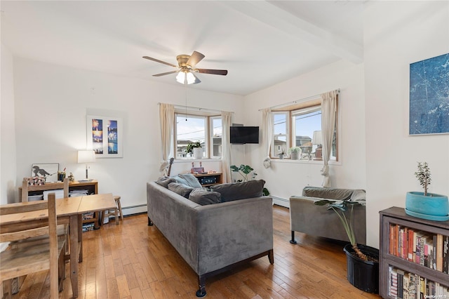 living room featuring baseboard heating, ceiling fan, and wood-type flooring