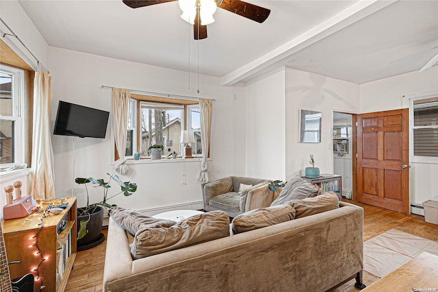 living room with ceiling fan, baseboard heating, and light hardwood / wood-style flooring