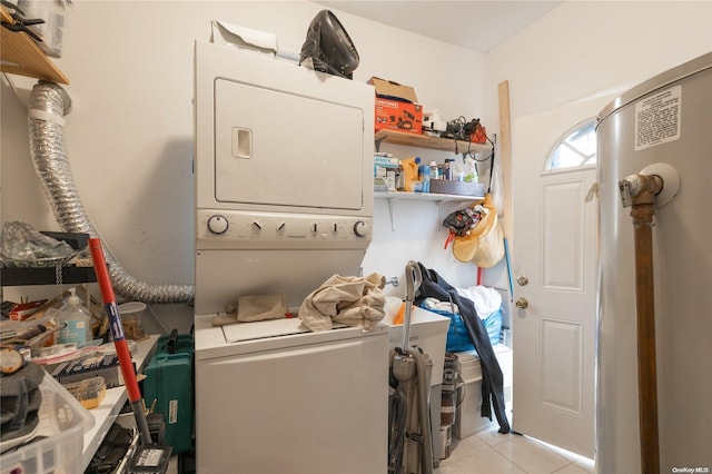 laundry area featuring light tile patterned floors and stacked washing maching and dryer