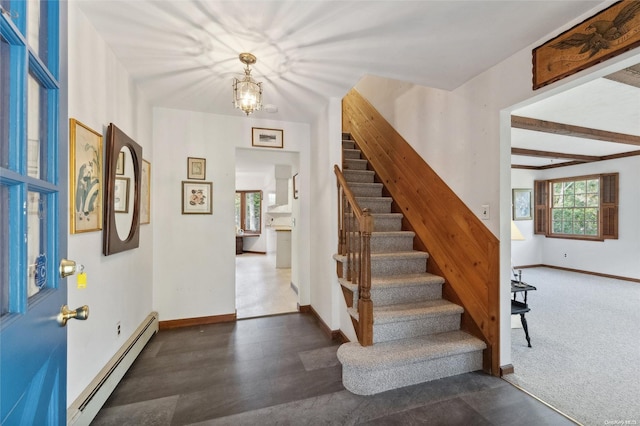 carpeted foyer with beamed ceiling, an inviting chandelier, and a baseboard radiator