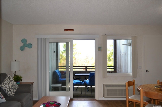 entryway with wood-type flooring, a textured ceiling, and radiator