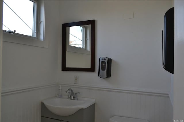 bathroom featuring vanity, toilet, and a wealth of natural light