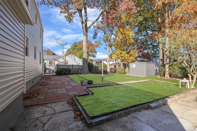 view of yard with a patio area and a storage unit