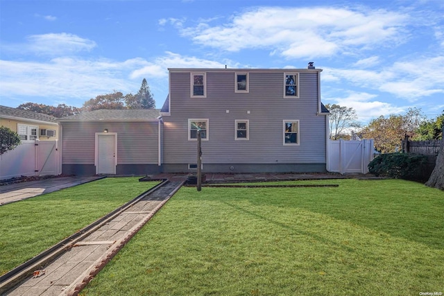 rear view of house featuring a yard