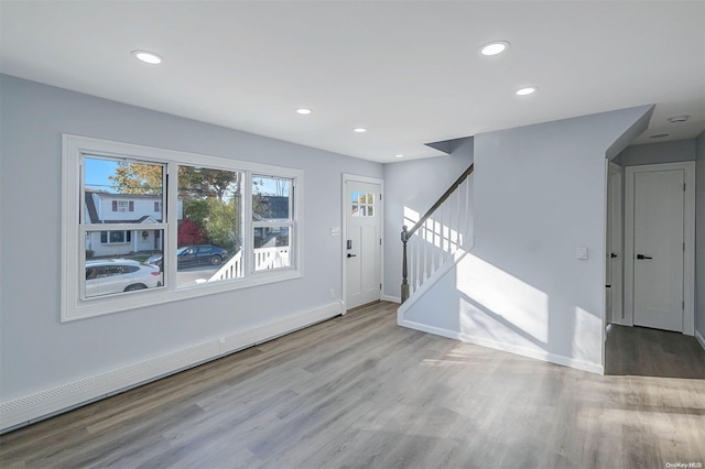 entrance foyer with hardwood / wood-style flooring and a baseboard heating unit