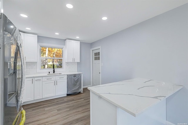 kitchen featuring white cabinets, appliances with stainless steel finishes, hardwood / wood-style flooring, and sink