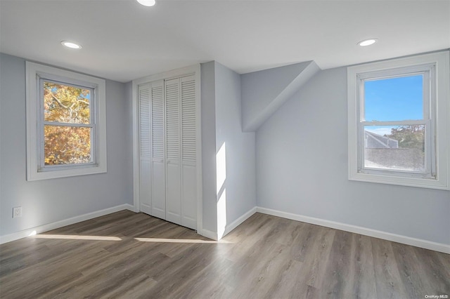 additional living space featuring light hardwood / wood-style floors