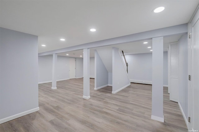 basement with light hardwood / wood-style floors