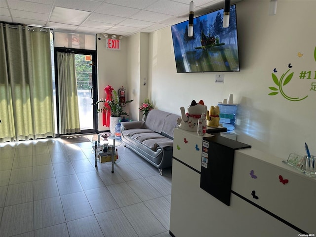 living room featuring a drop ceiling