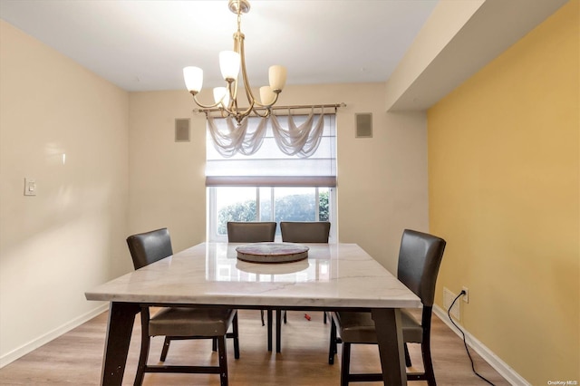 dining space featuring a chandelier and wood-type flooring