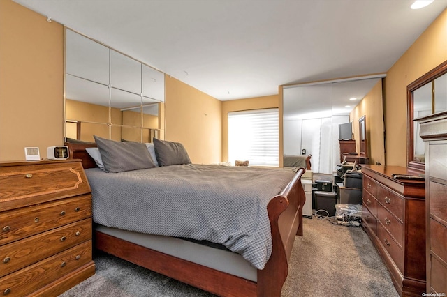 bedroom featuring dark colored carpet