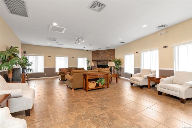 living room featuring a fireplace and light tile patterned floors