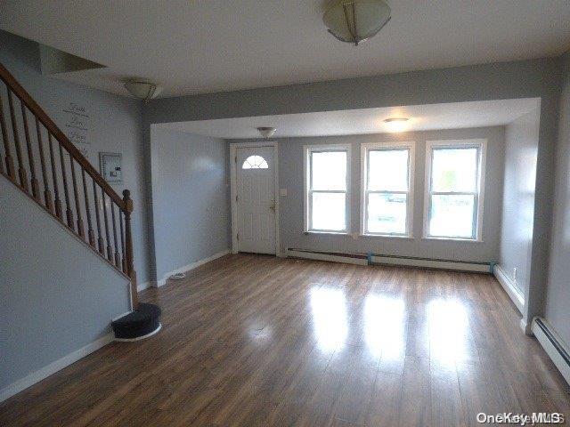 entrance foyer featuring hardwood / wood-style floors and a baseboard radiator