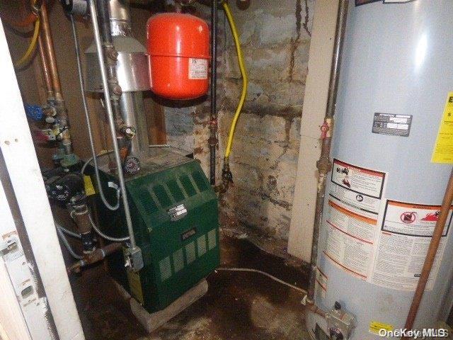 utility room featuring water heater