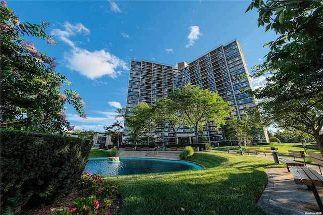 view of pool featuring a lawn