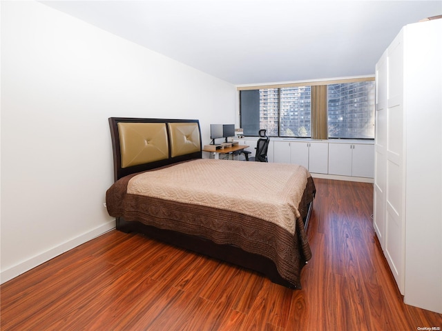 bedroom featuring dark wood-type flooring