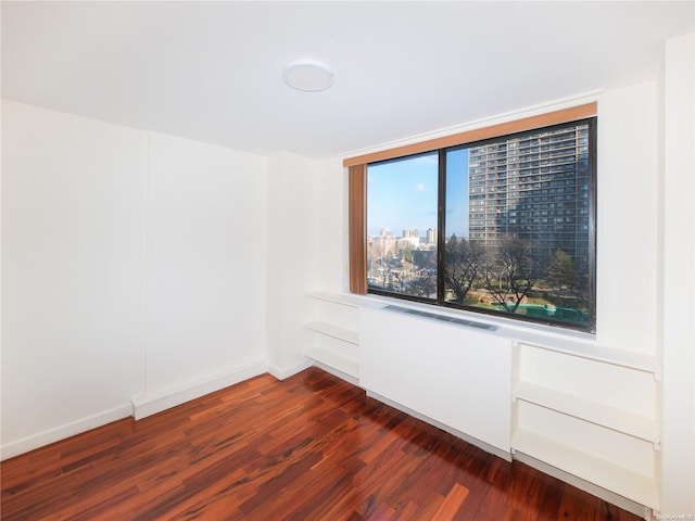 unfurnished room featuring dark hardwood / wood-style flooring