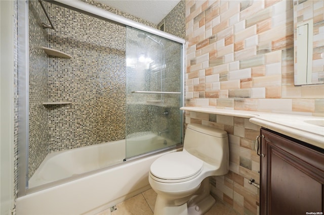 full bathroom featuring tile patterned flooring, vanity, tile walls, and shower / bath combination with glass door